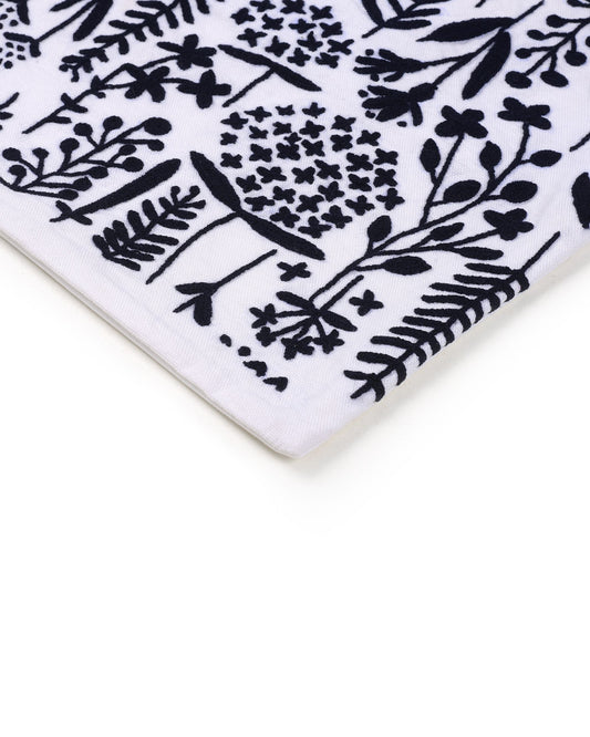 Close-up of a white ceramic cushion cover  with black floral pattern