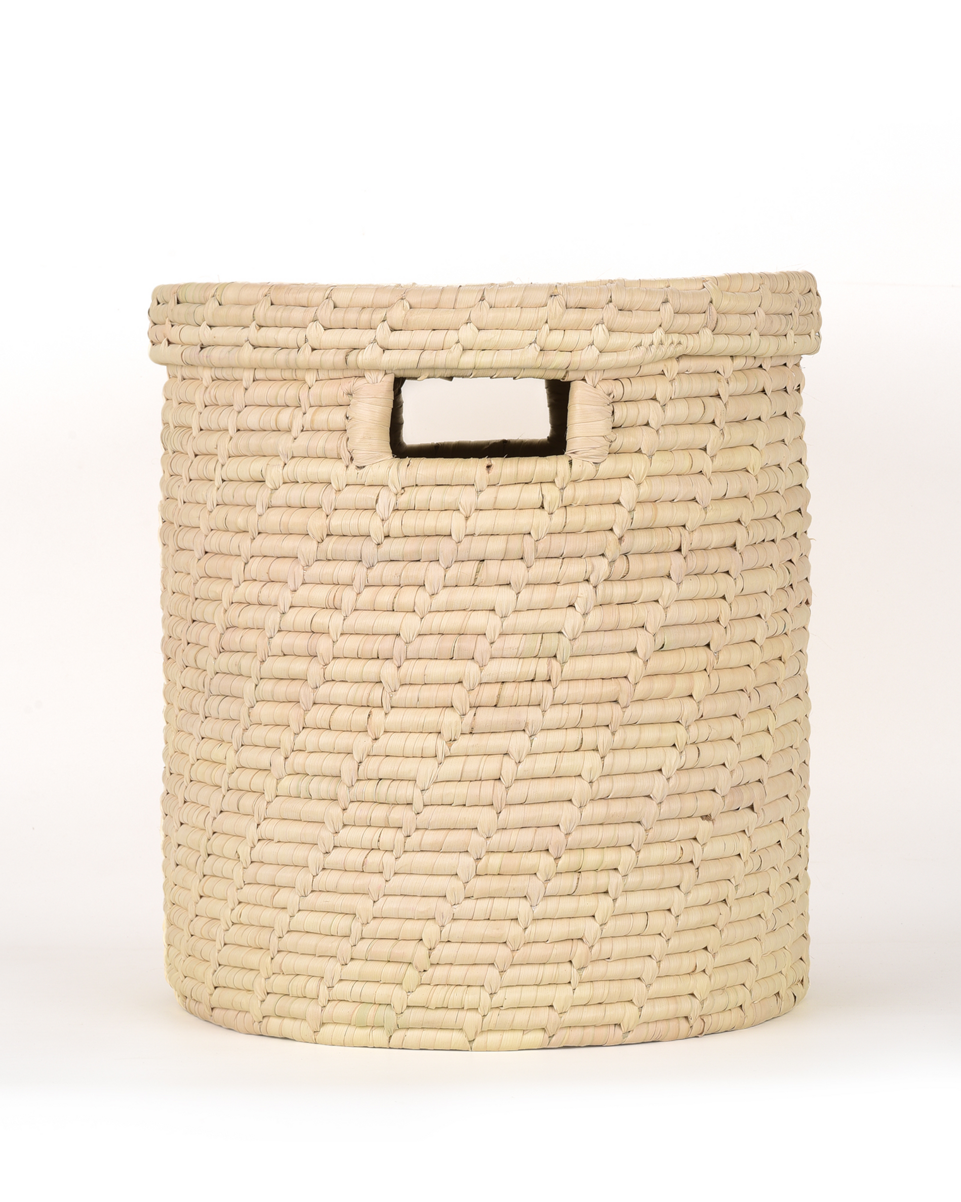 Woven beige basket with a handle on a white background