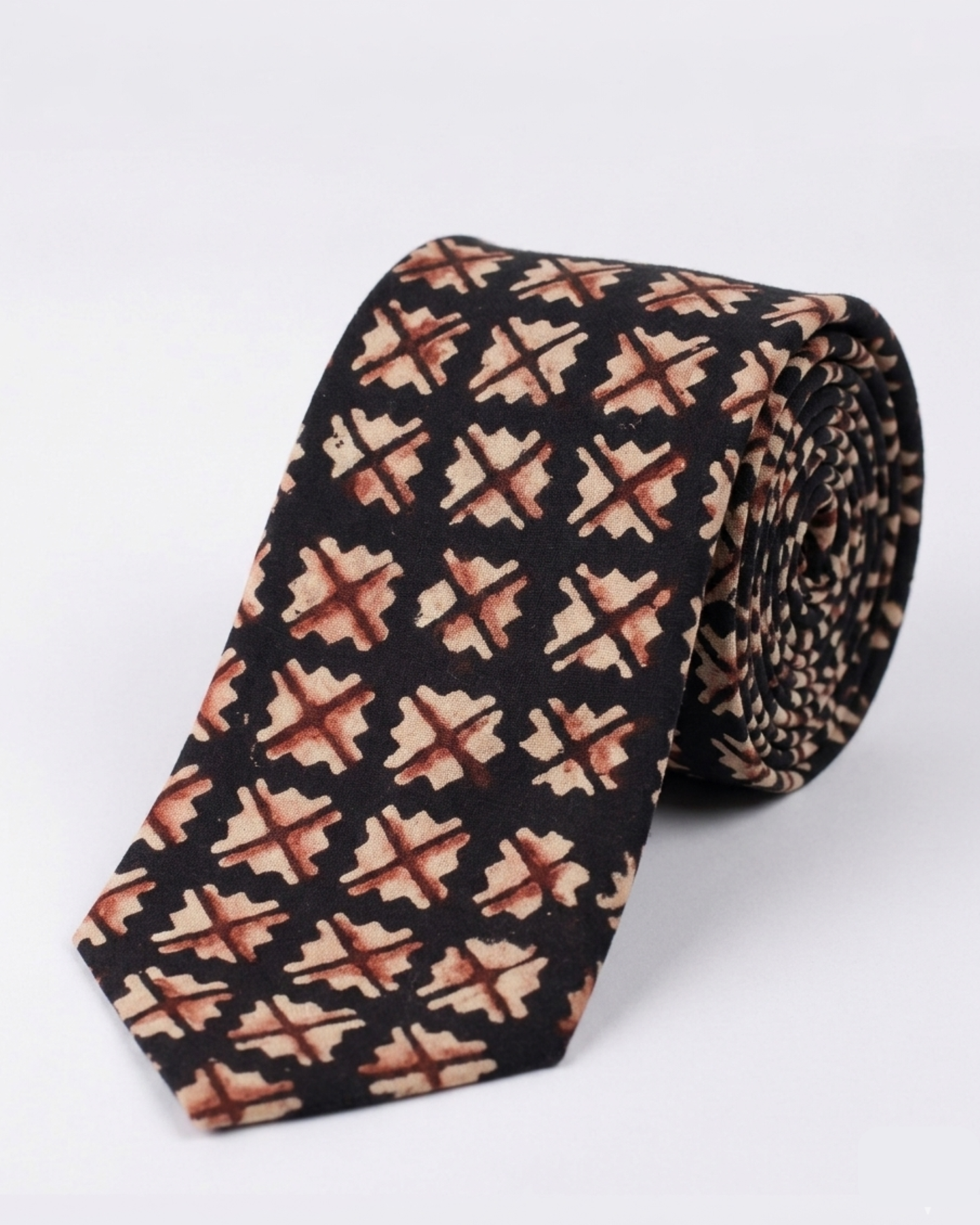 Natural dye hand block print cotton tie with near black base and sand camel burnt rust geometric cross diamond motifs handcrafted in Sindh Pakistan