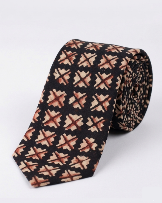 Natural dye hand block print cotton tie with near black base and sand camel burnt rust geometric cross diamond motifs handcrafted in Sindh Pakistan
