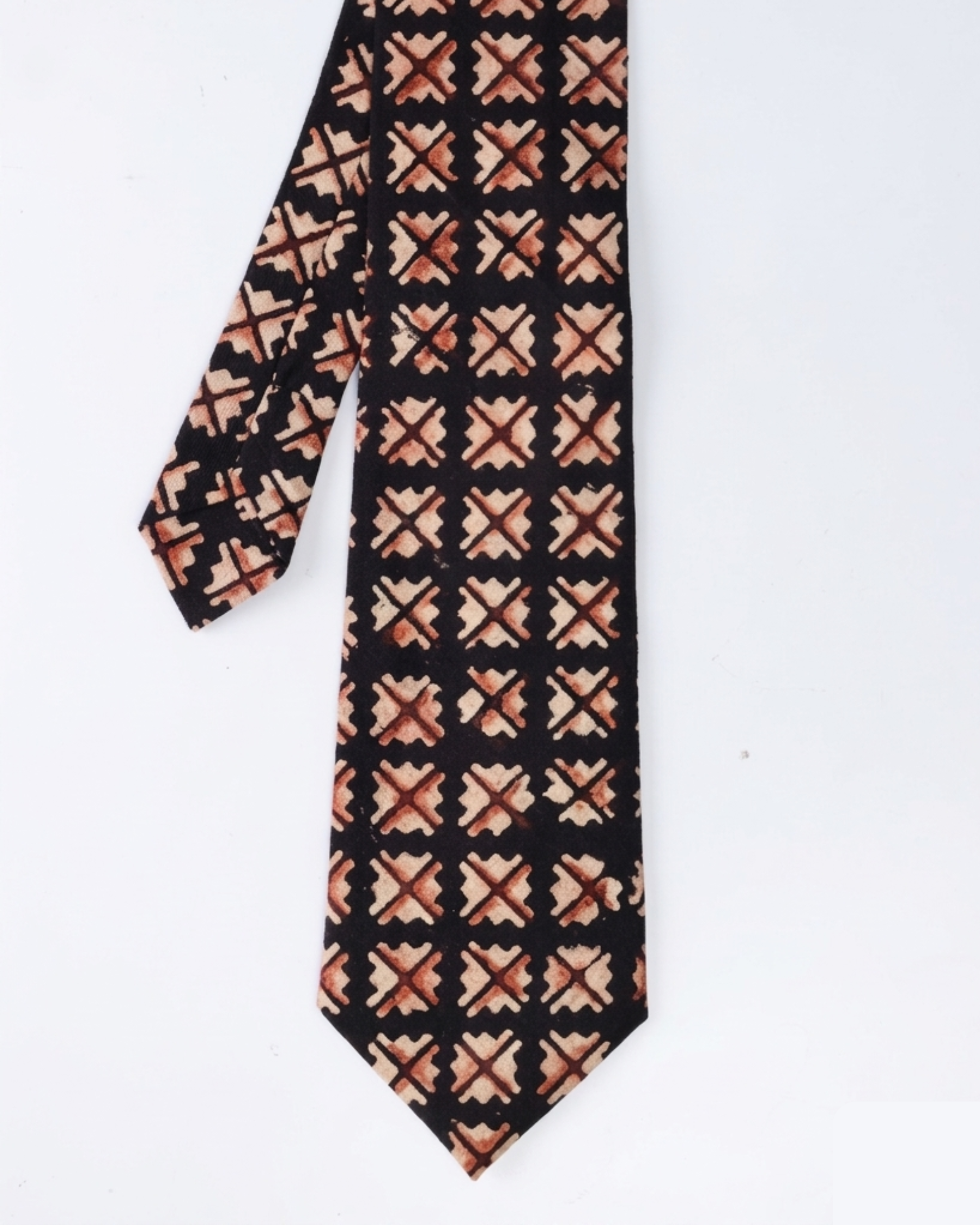 Natural dye hand block print cotton tie with near black base and sand camel burnt rust geometric cross diamond motifs handcrafted in Sindh Pakistan