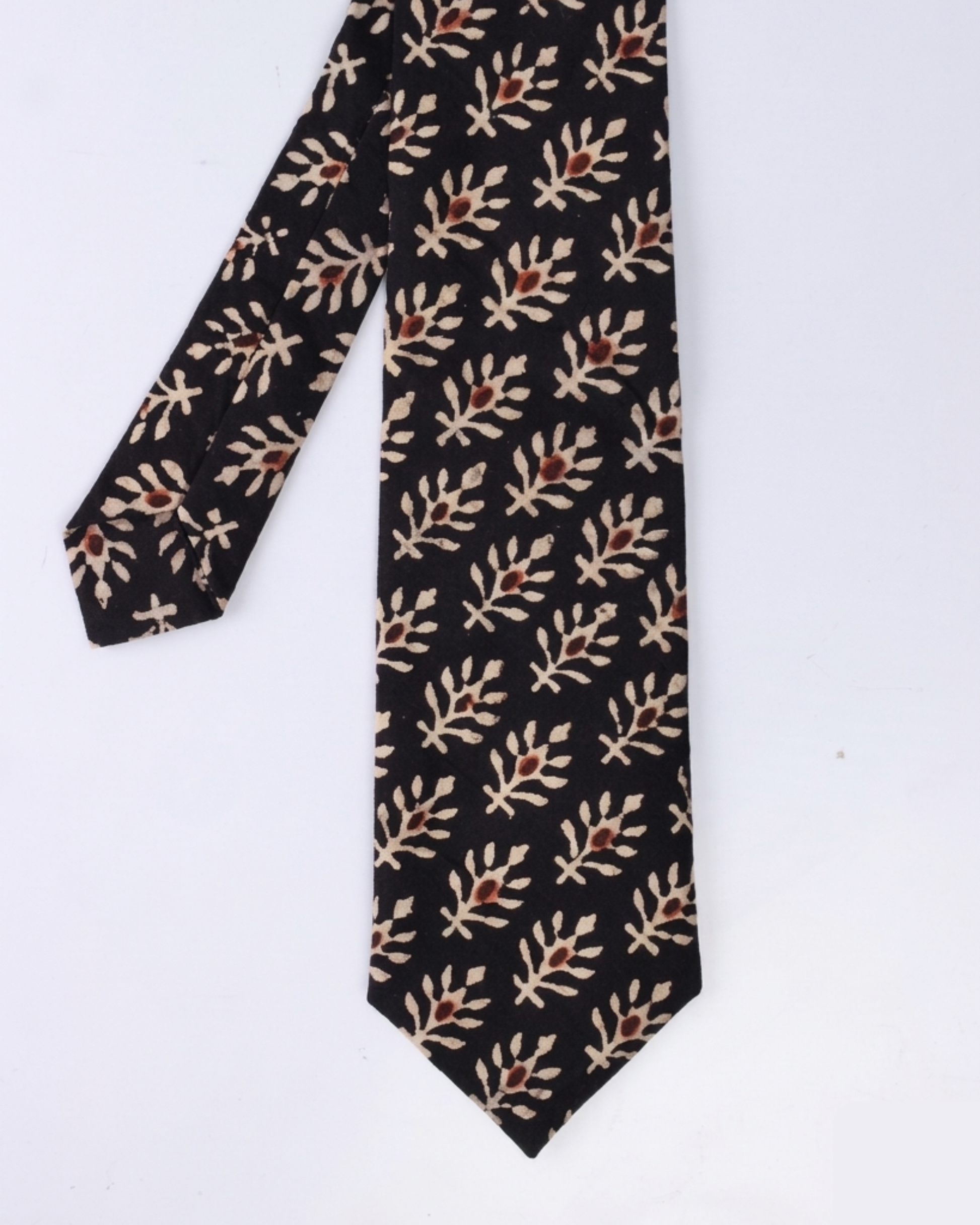 
Natural dye hand block print cotton tie with pure black base and cream botanical leaf sprigs with rust brown flower bud motifs handcrafted in Sindh PakistanYou said: color