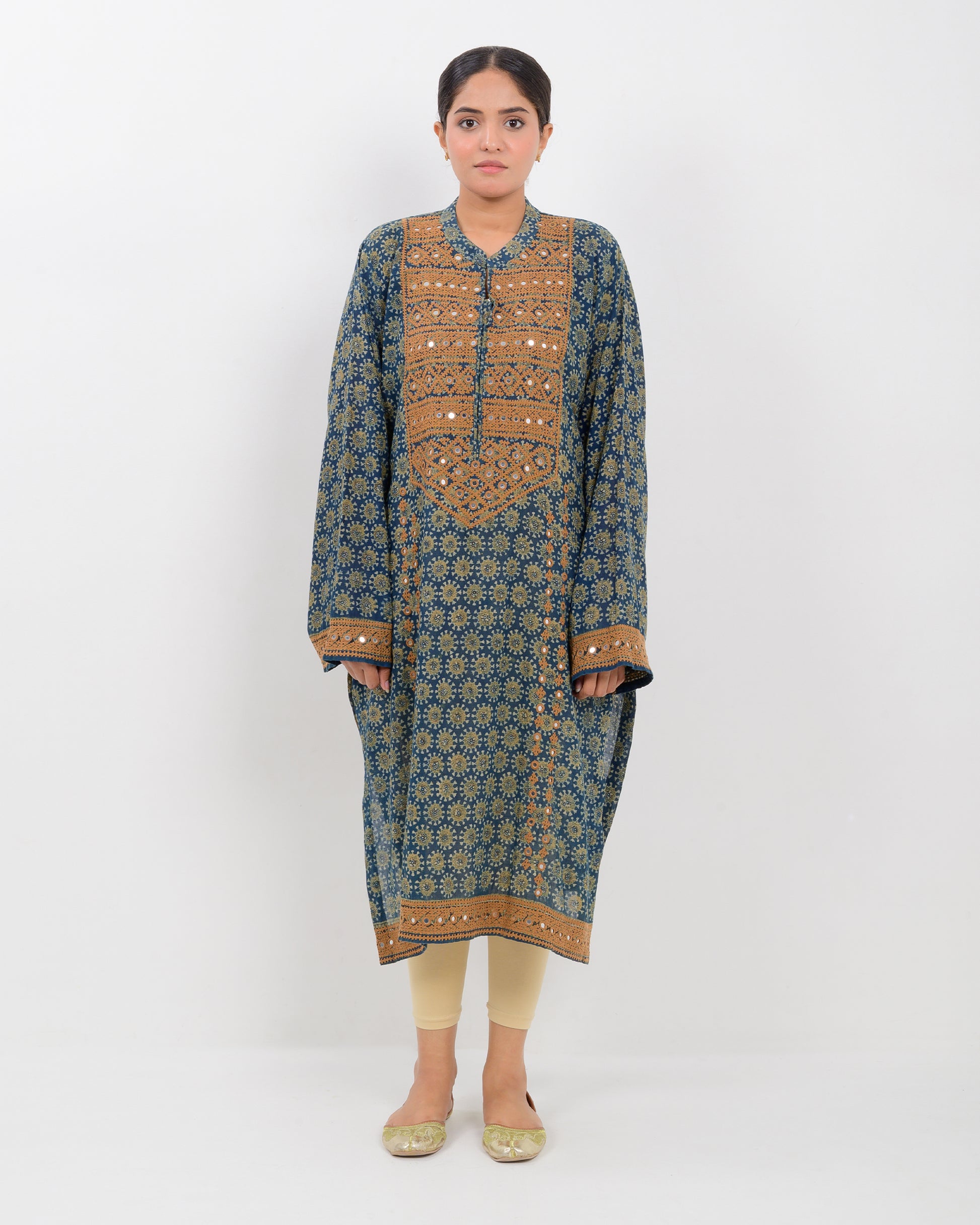 Woman wearing a hurmich mirror work natural dye shirt on a white background