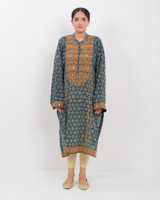 Woman wearing a hurmich mirror work natural dye shirt on a white background