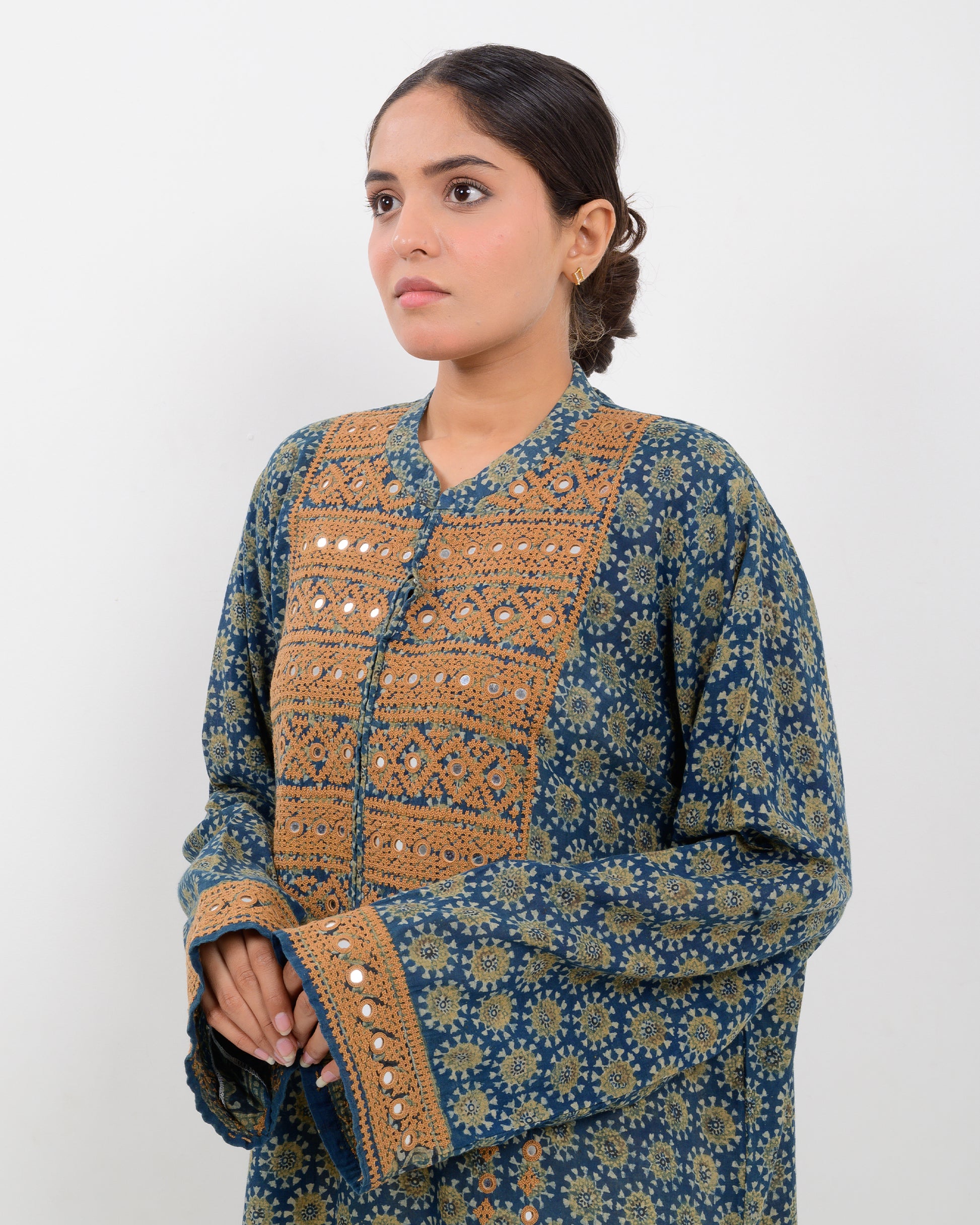 Woman wearing a hurmich mirror work natural dye shirt on a white background