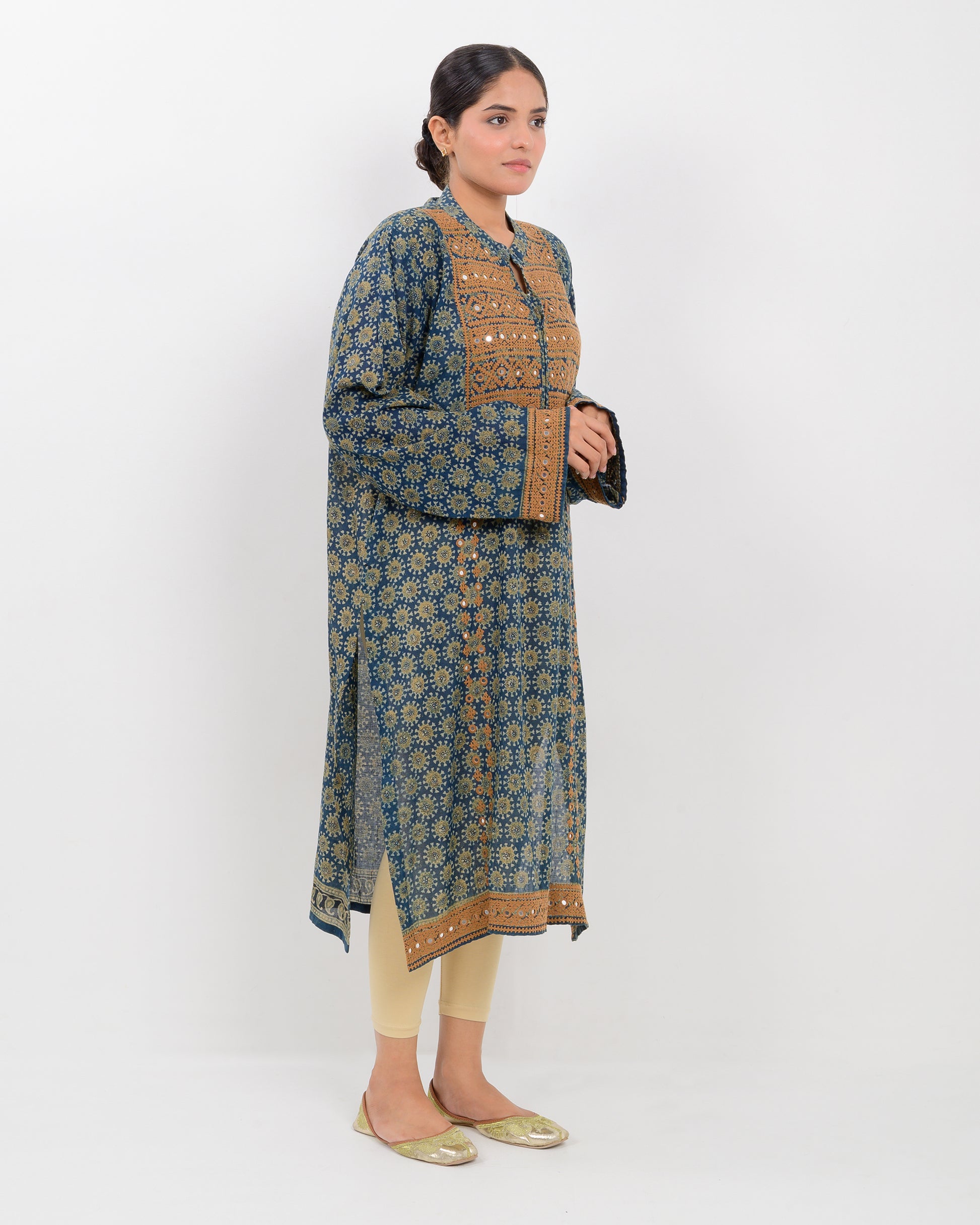 Woman wearing a hurmich mirror work natural dye shirt on a white background