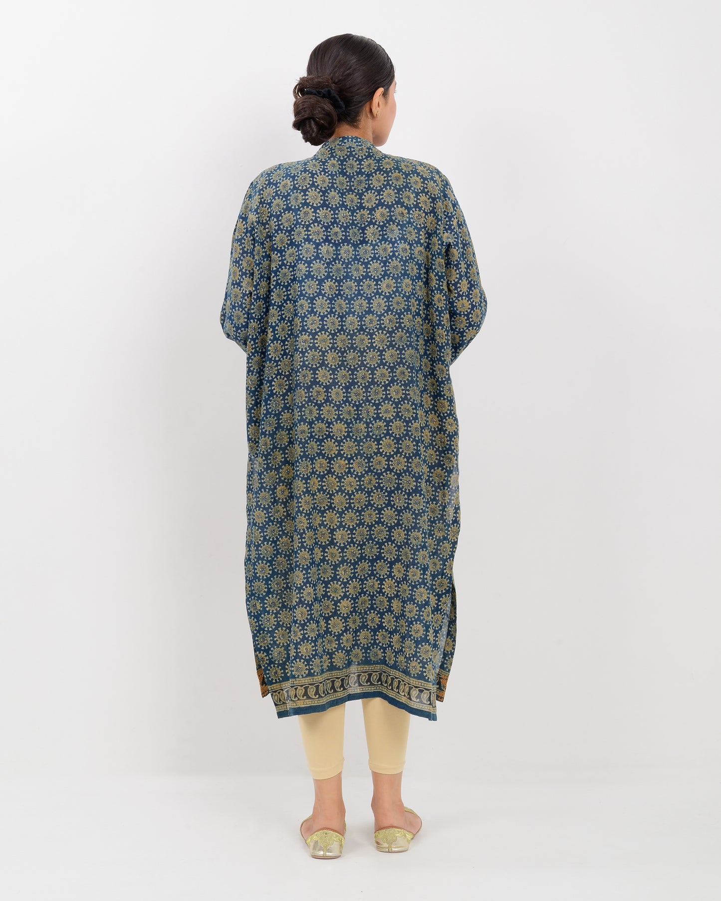 Woman wearing a hurmich mirror work natural dye shirt on a white background