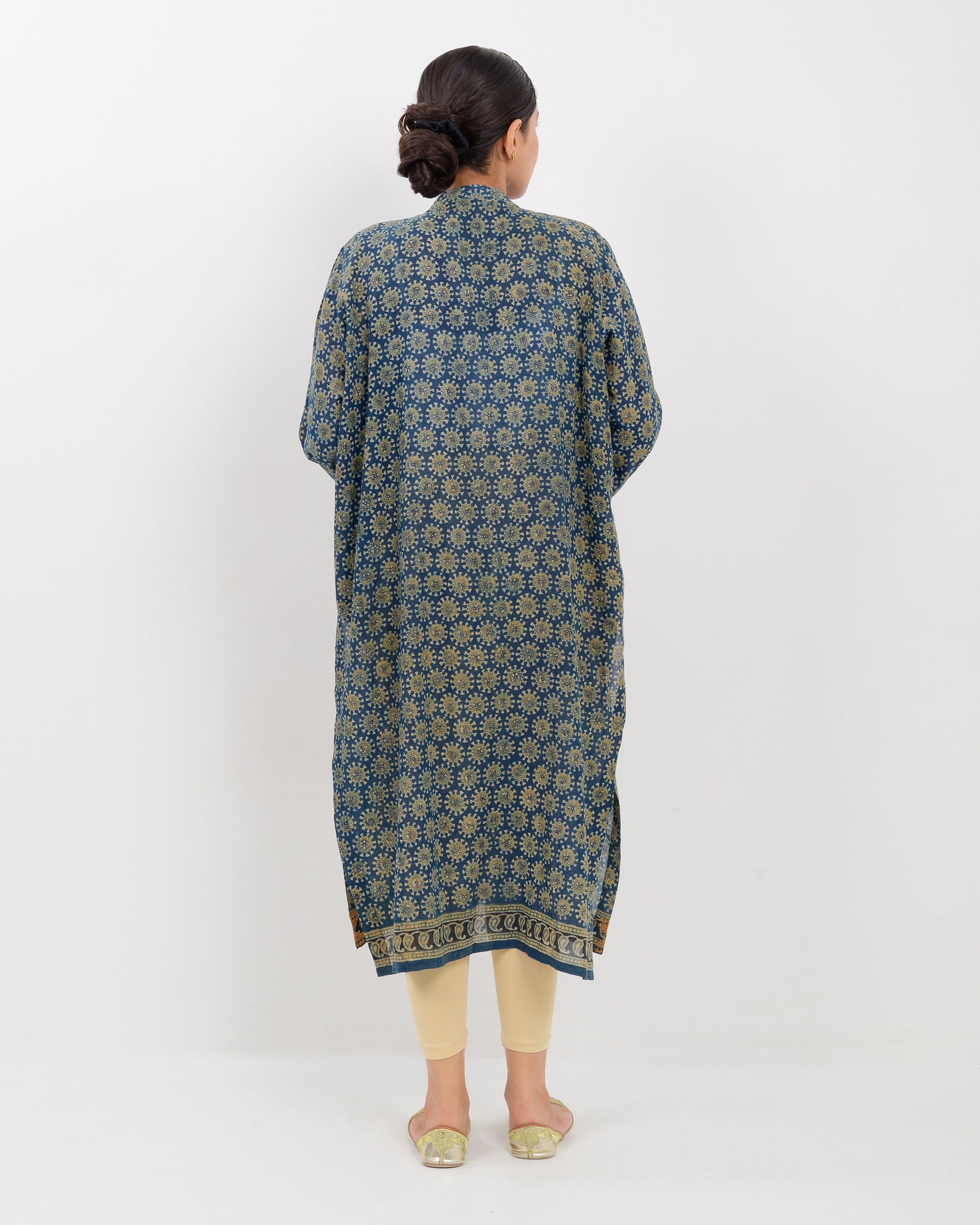 Woman wearing a hurmich mirror work natural dye shirt on a white background