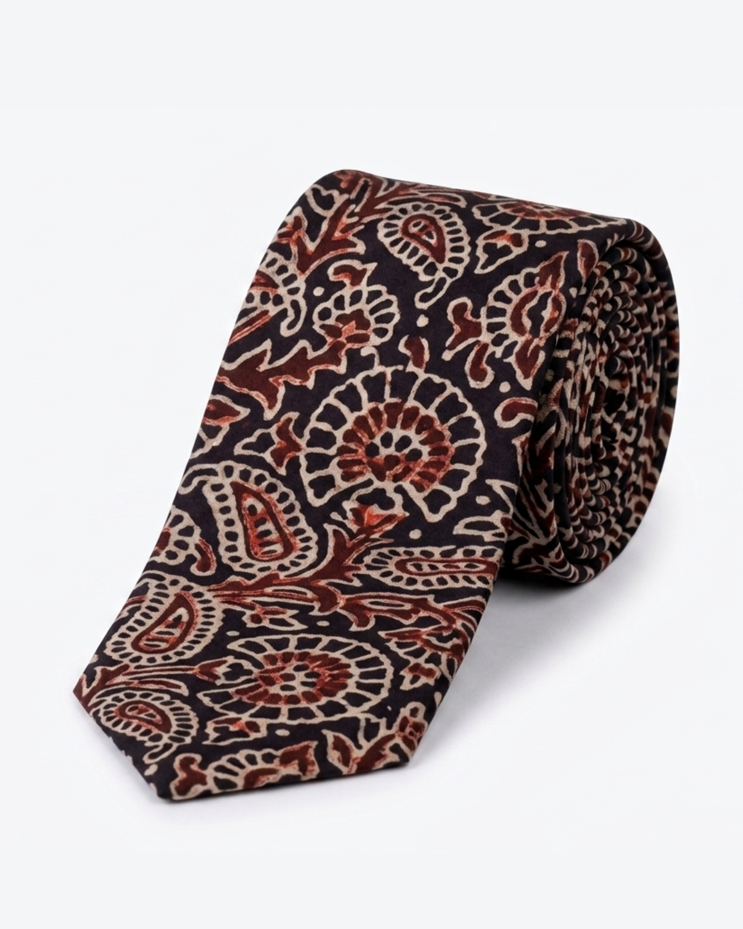 Natural dye hand block print silk tie with near black base and oversized paisley floral motifs in terracotta burnt sienna and antique cream handcrafted in Sindh Pakistan