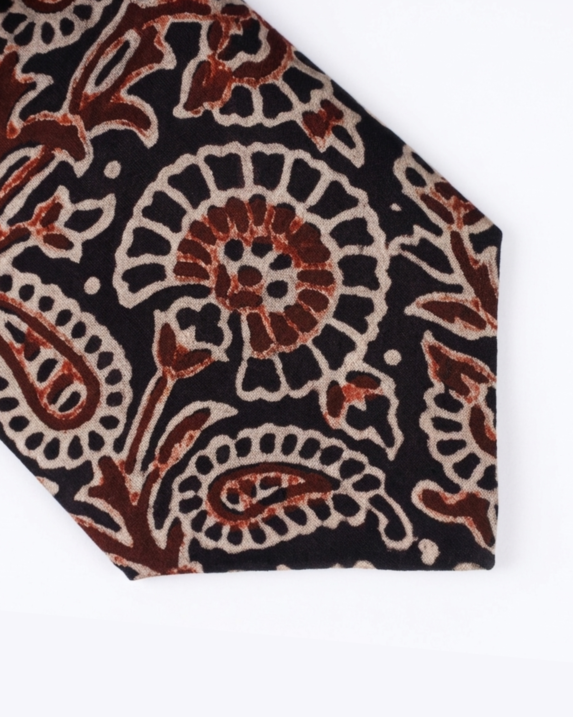 Natural dye hand block print silk tie with near black base and oversized paisley floral motifs in terracotta burnt sienna and antique cream handcrafted in Sindh Pakistan