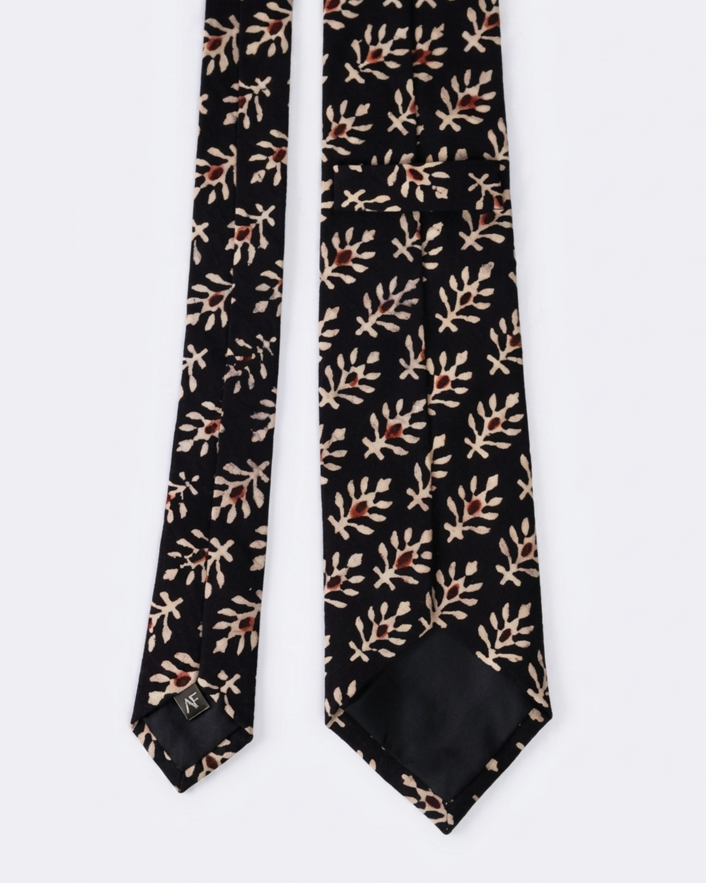 
Natural dye hand block print cotton tie with pure black base and cream botanical leaf sprigs with rust brown flower bud motifs handcrafted in Sindh PakistanYou said: color