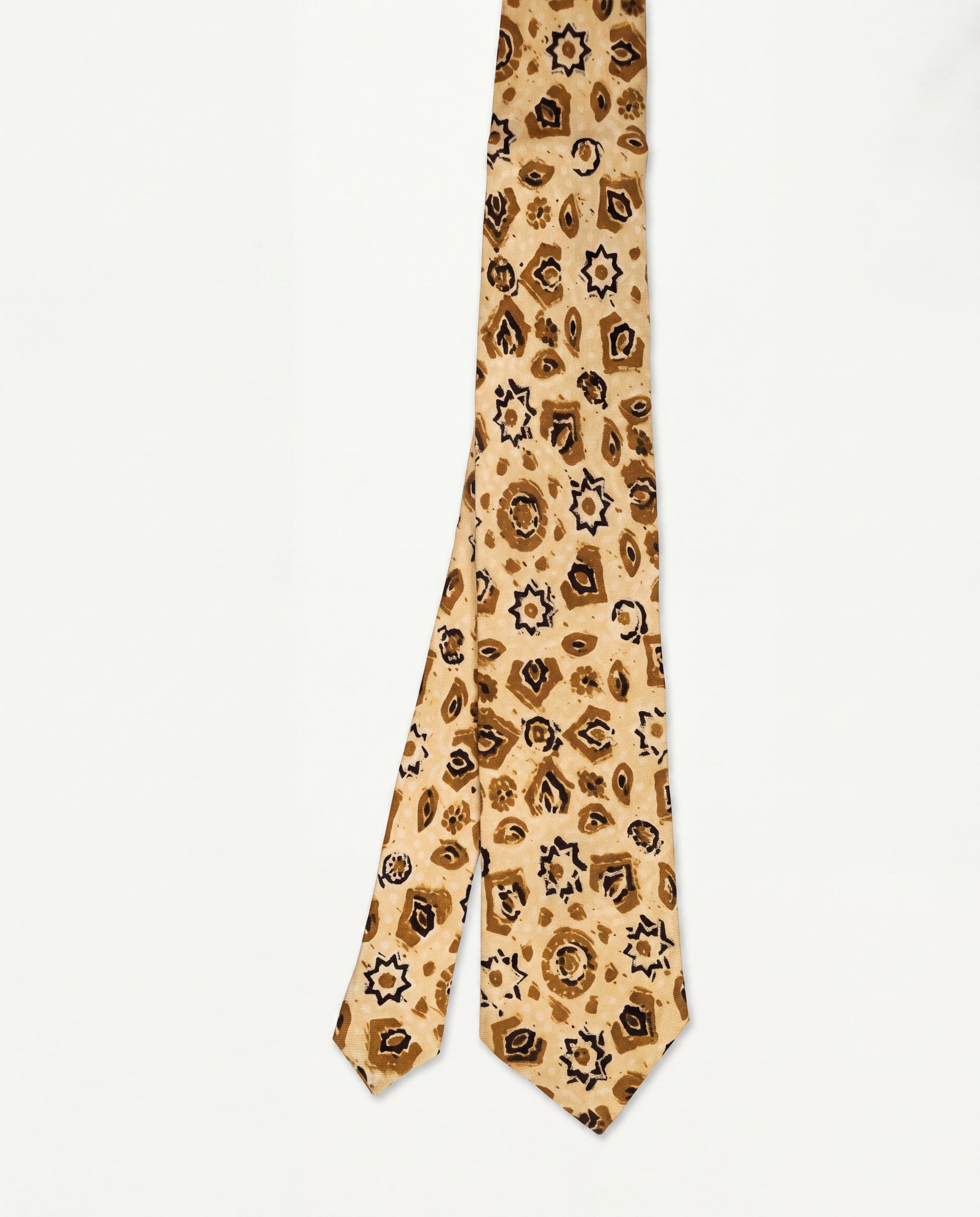 A leopard-print necktie in beige and brown, laid flat against a clean white background.
