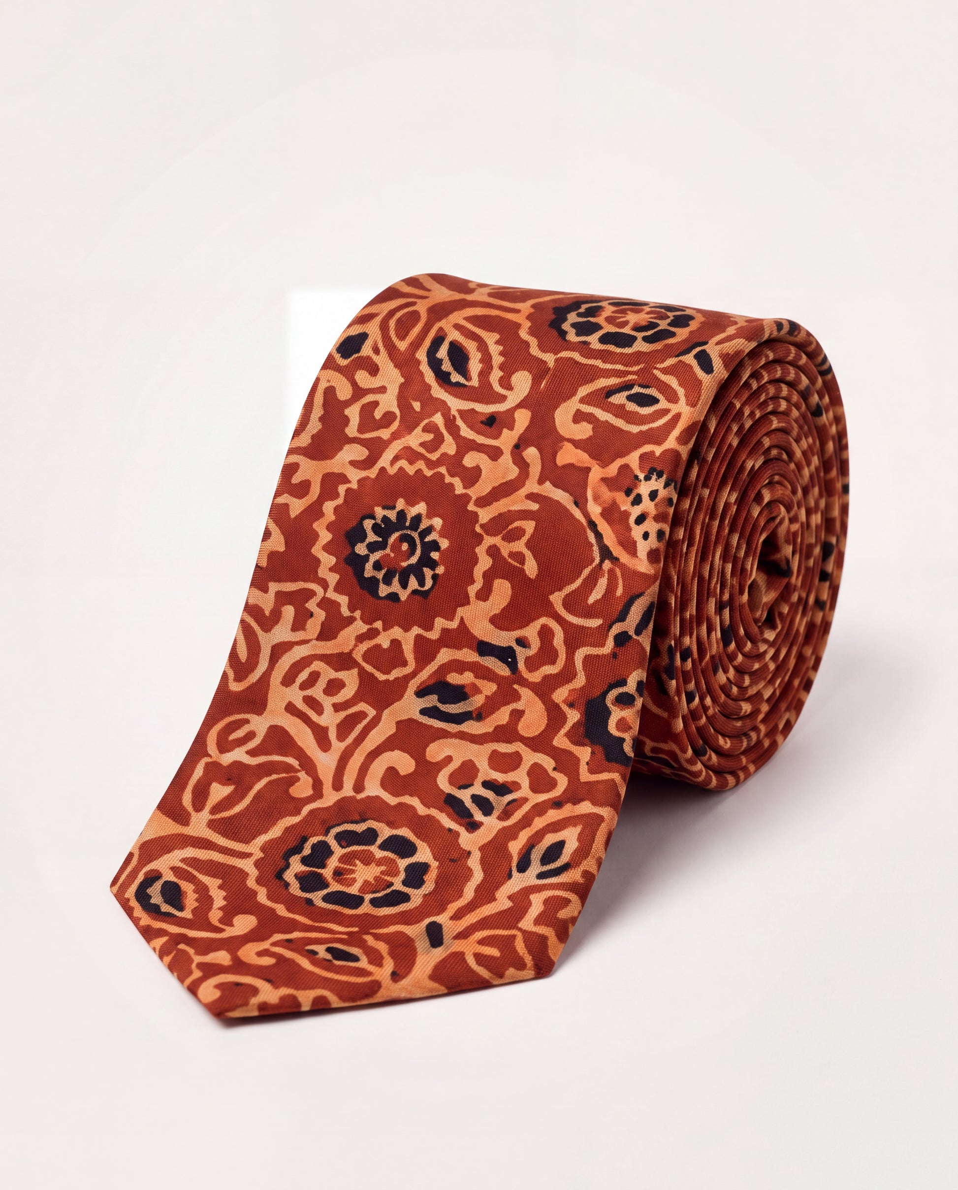 Handcrafted natural dye block print silk necktie in rust and terracotta floral pattern made from premium silk, displayed for luxury men's fashion.
