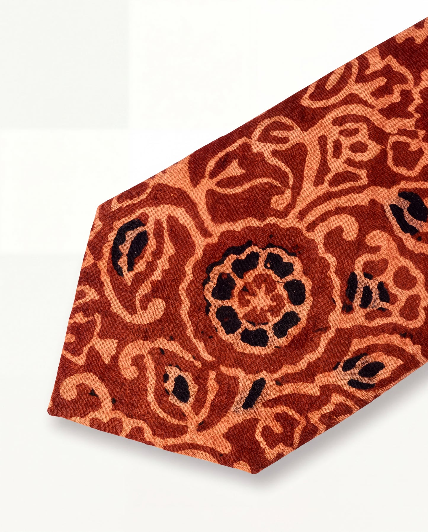 Handcrafted natural dye block print silk necktie in rust and terracotta floral pattern made from premium silk, displayed for luxury men's fashion.