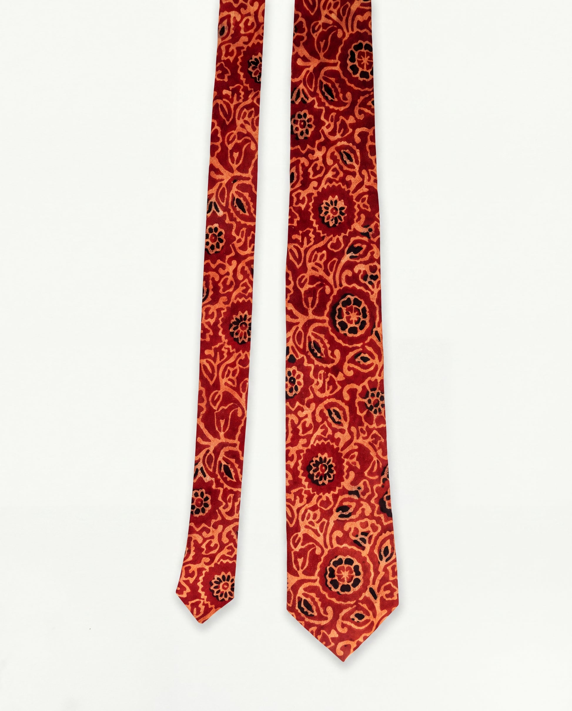 Handcrafted natural dye block print silk necktie in rust and terracotta floral pattern made from premium silk, displayed for luxury men's fashion.