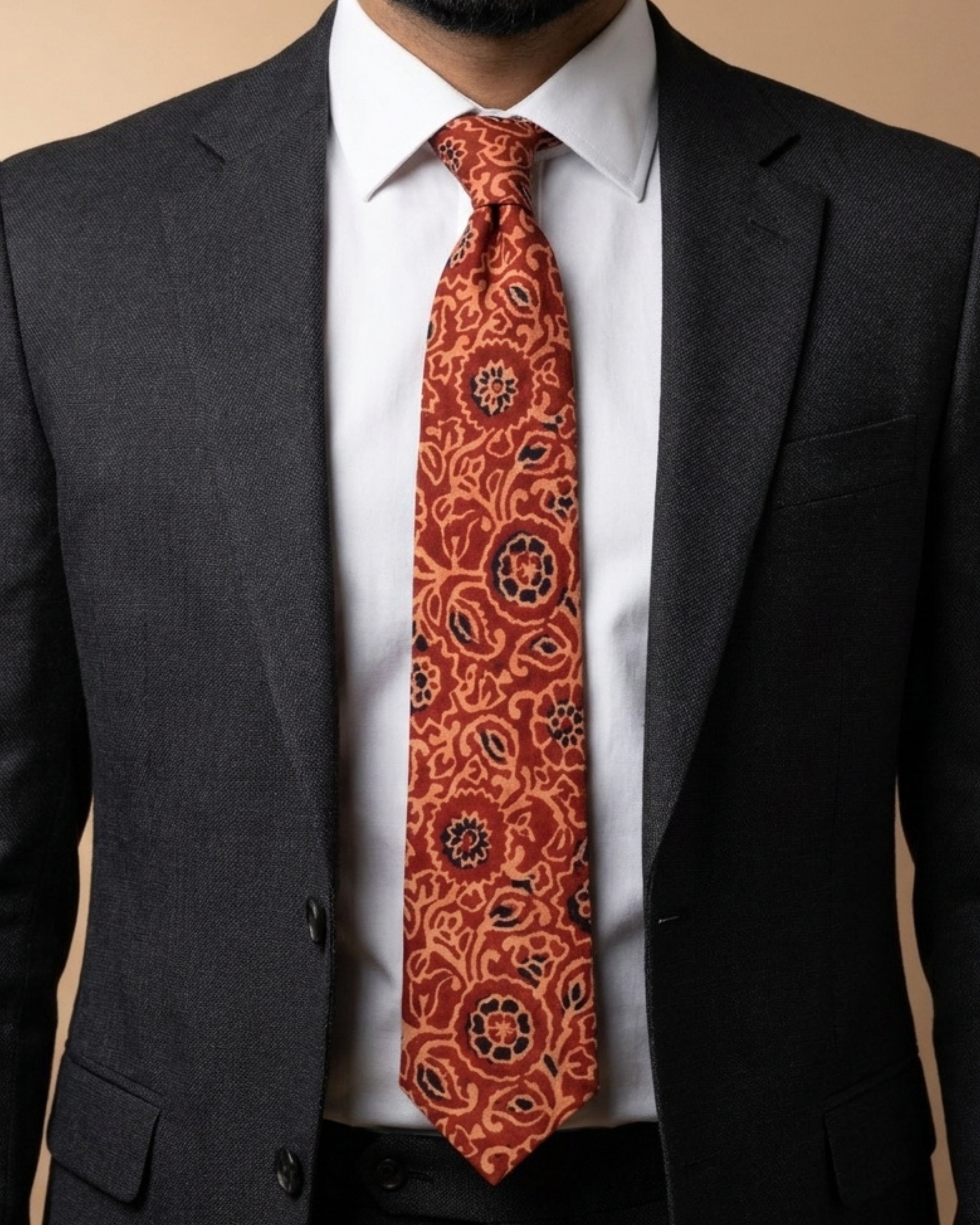 Handcrafted natural dye block print silk necktie in rust and terracotta floral pattern made from premium silk, displayed for luxury men's fashion.