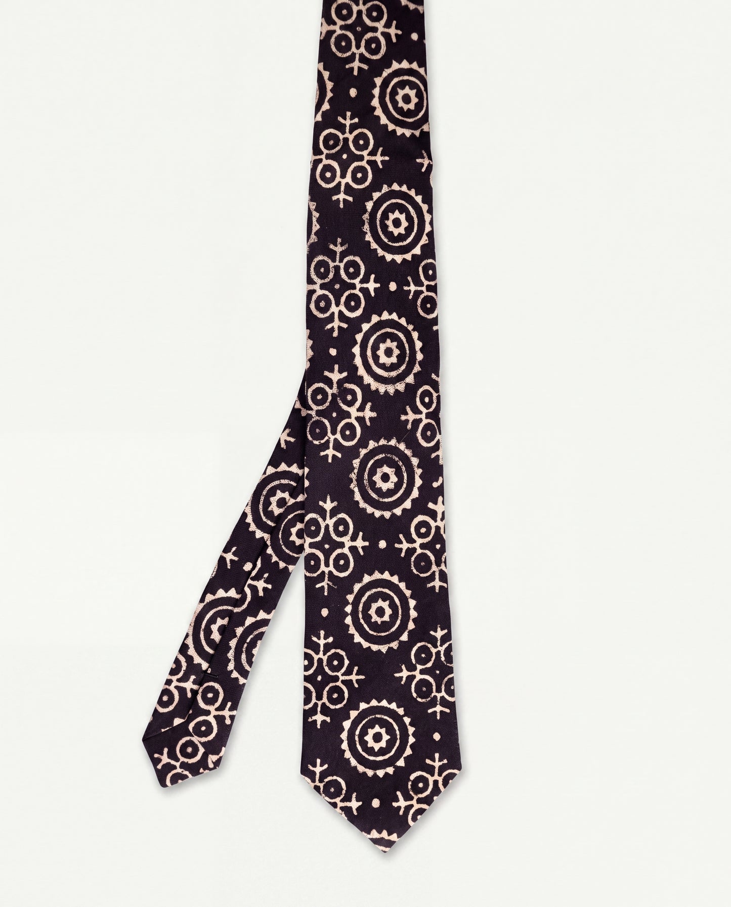Lunar Eclipse natural dye Ajrak hand block print cotton tie in black with ivory geometric motifs, handcrafted by artisans in Sindh, Pakistan.