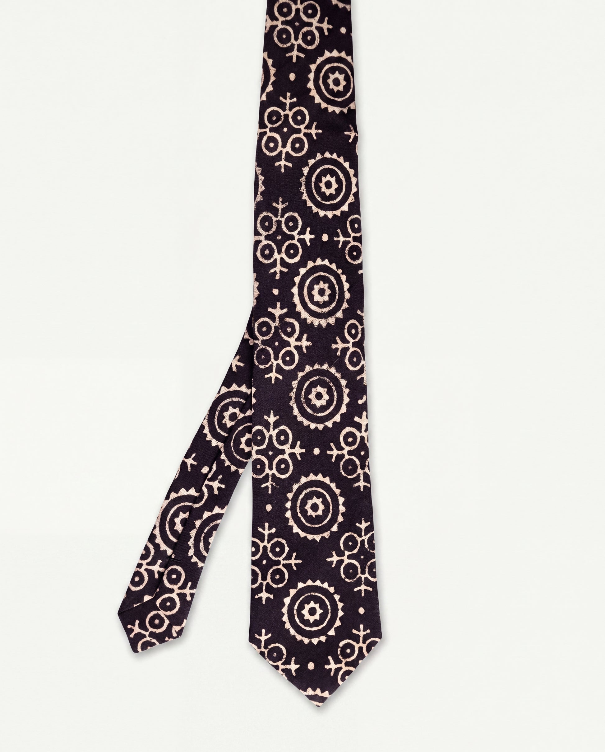 Lunar Eclipse natural dye Ajrak hand block print cotton tie in black with ivory geometric motifs, handcrafted by artisans in Sindh, Pakistan.