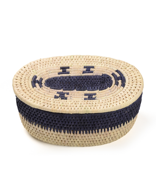 Woven basket with navy blue accents on a white background