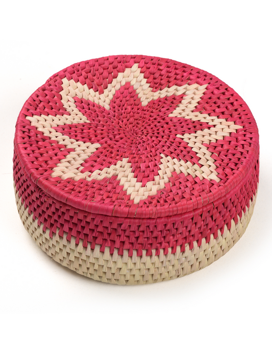 Round woven box with pink and beige star design on a white background