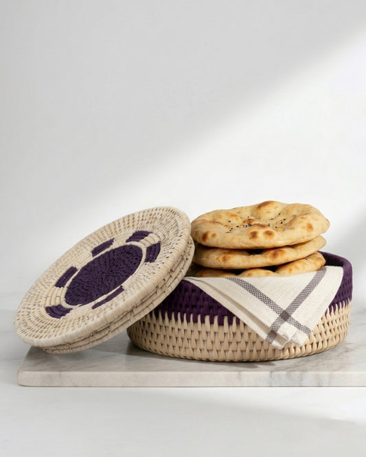 Woven basket with a lid and flatbreads on a white background