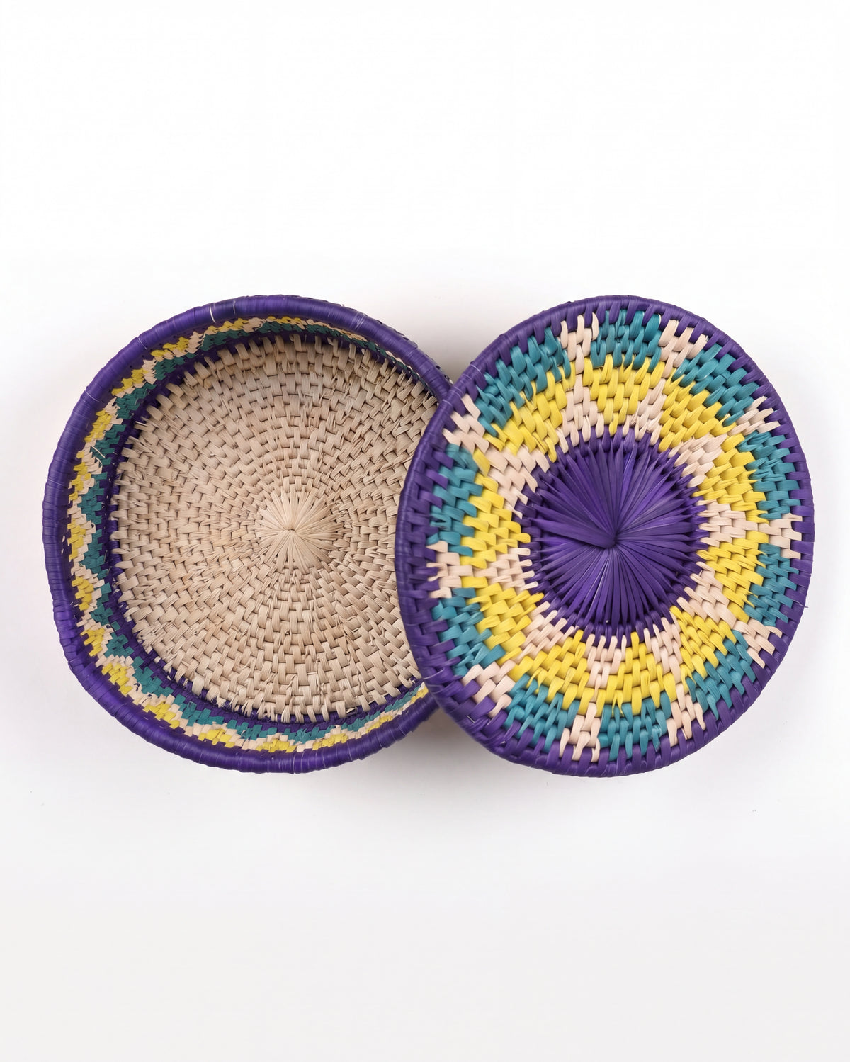 Two round woven baskets with lids, displayed on a clean white background. One basket is open, showing a natural beige woven interior with purple, yellow, and teal patterned rims.