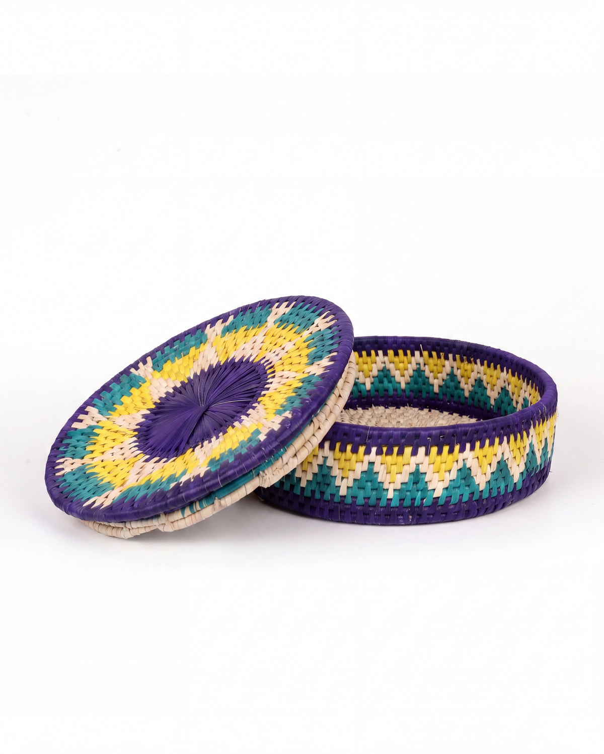 A small woven basket box with a matching lid, featuring a purple, yellow, teal, and cream geometric pattern, shown on a white background.