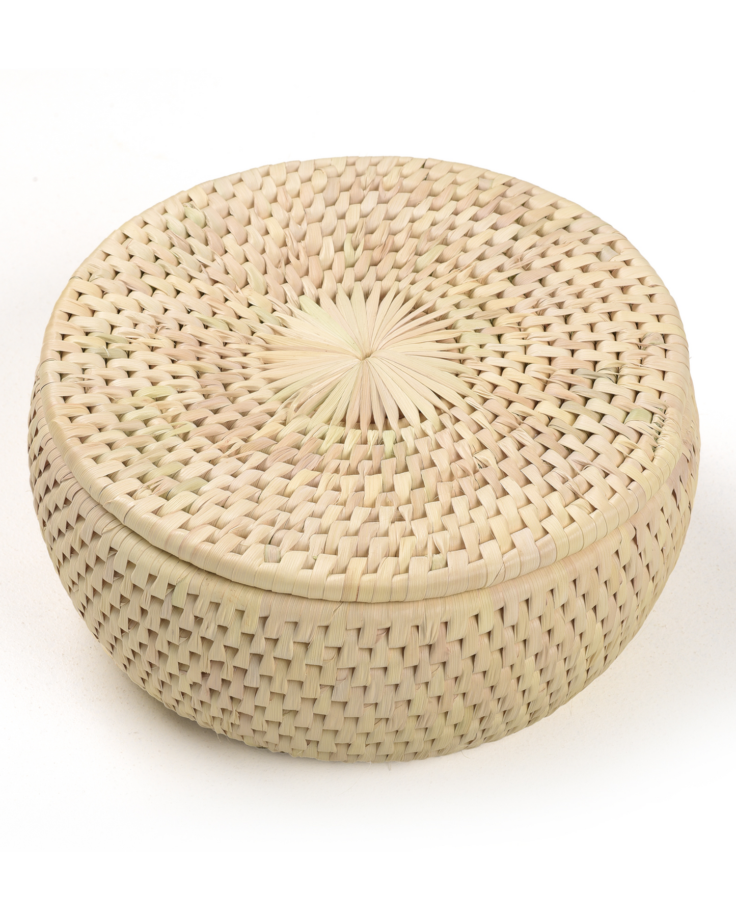 Woven basket with lid on a white background