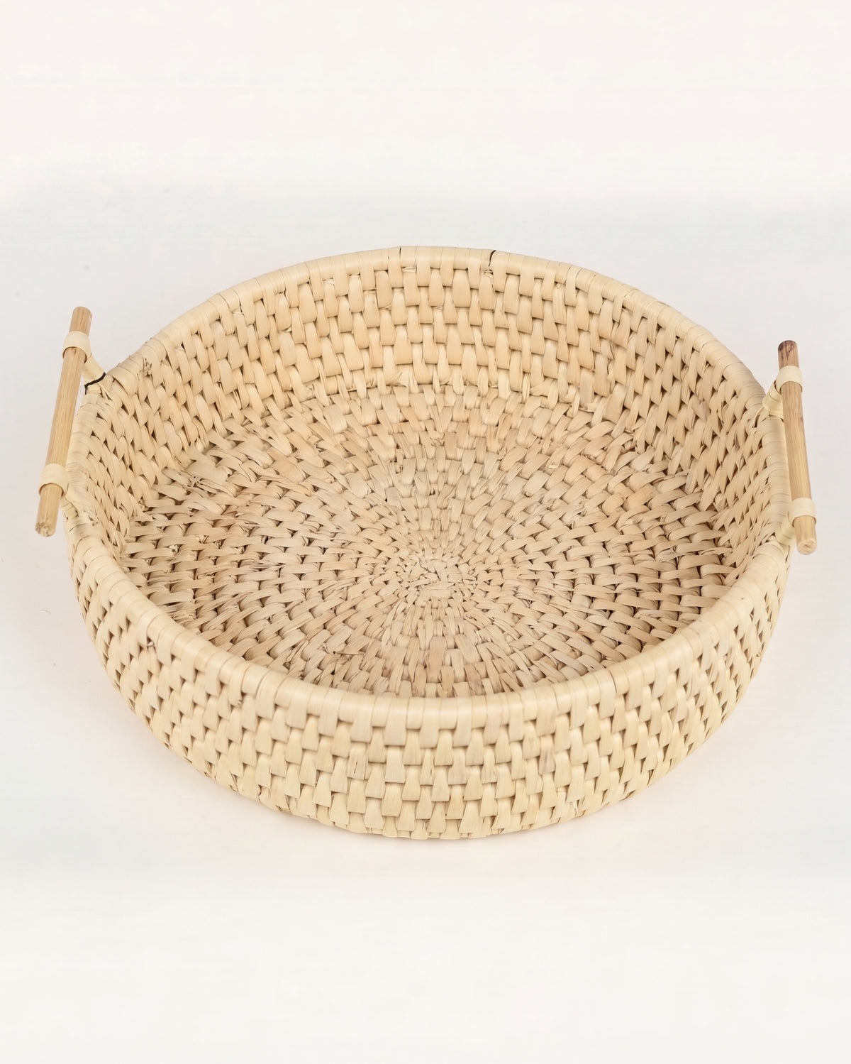 A round woven natural fiber basket with two light wood handles, photographed on a clean white background.