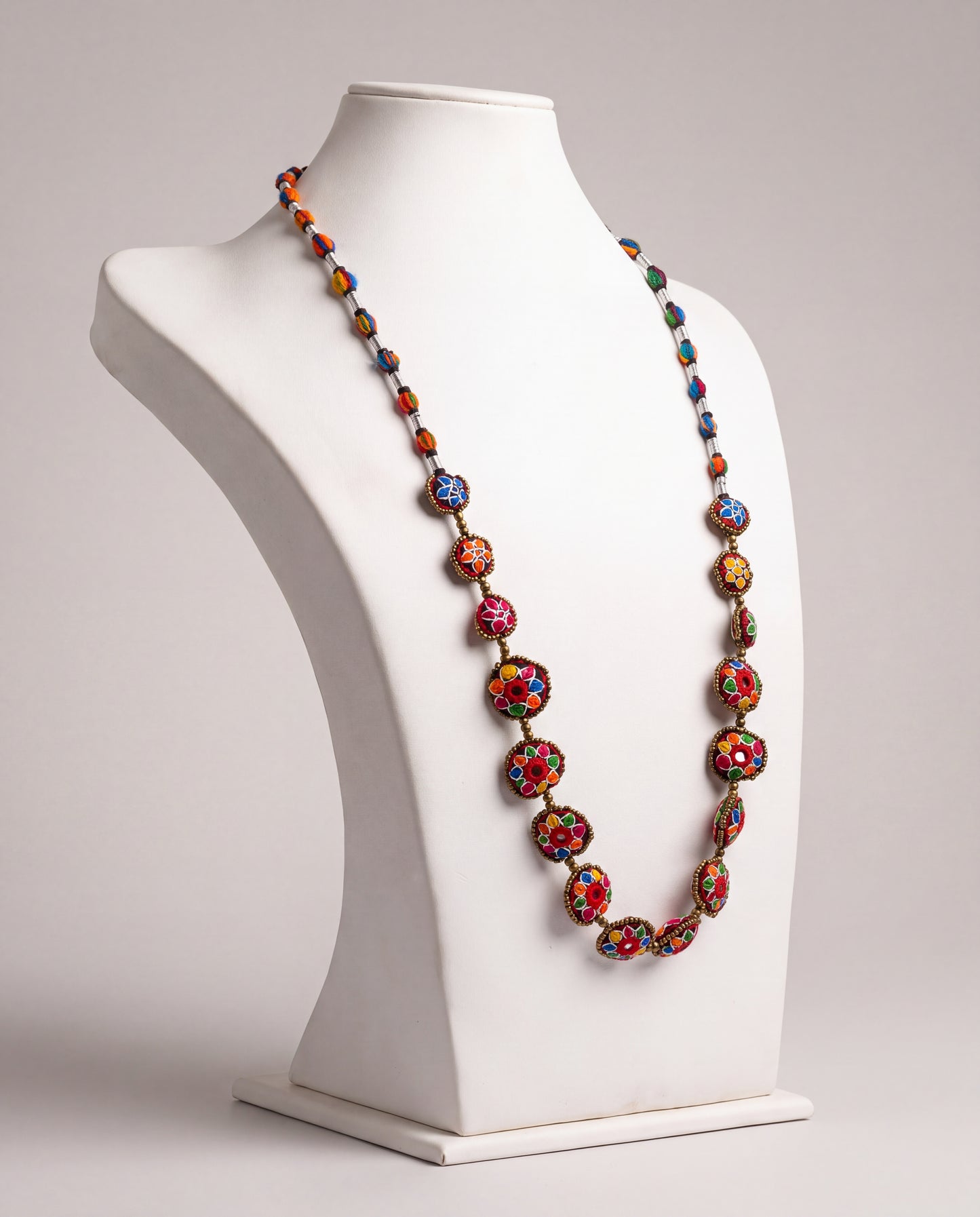 Handmade Balochi mirror flower necklace with colorful embroidered floral motifs, golden beads, silver thread, and traditional artisan craftsmanship from Pakistan.