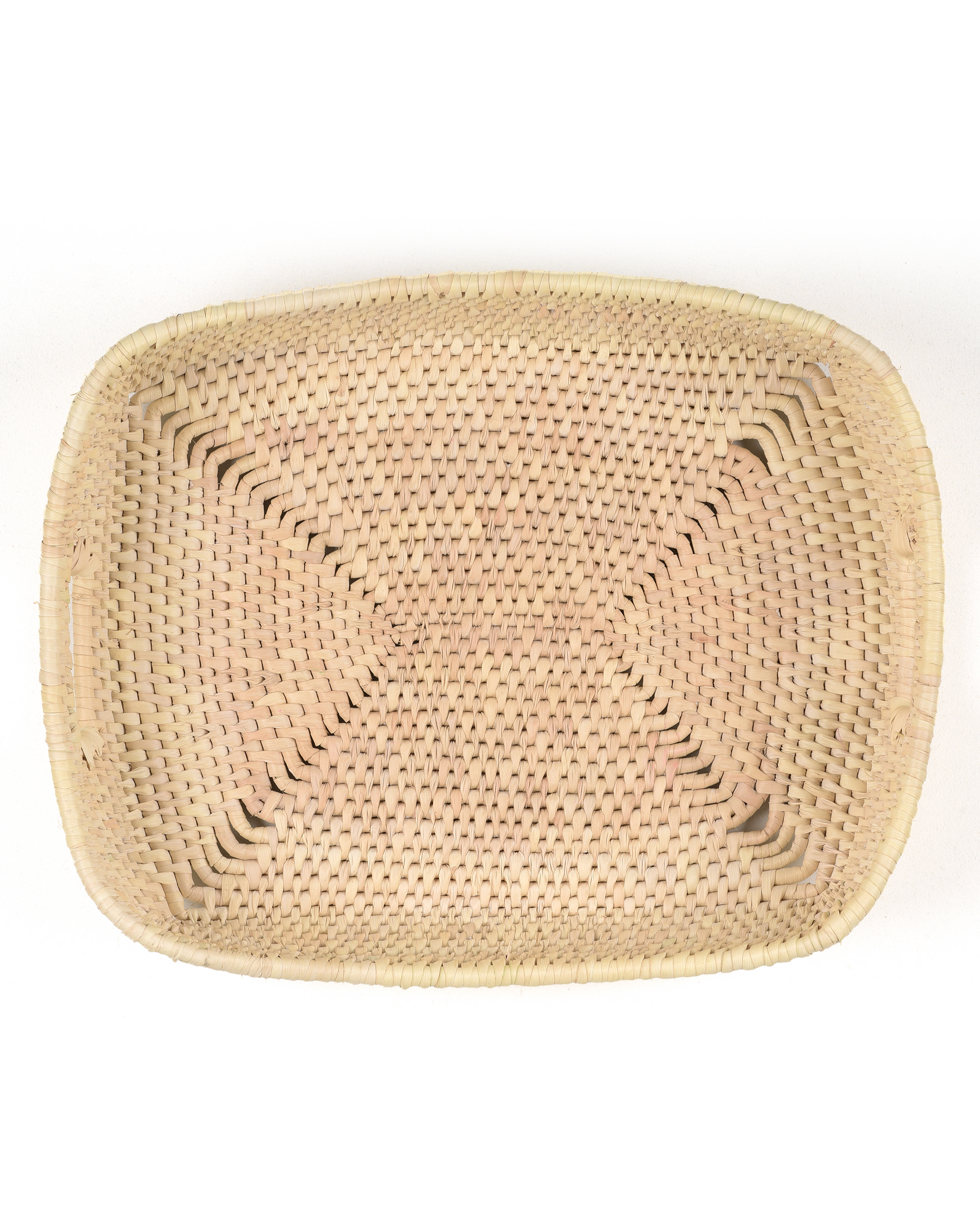 Woven beige mat on a white background