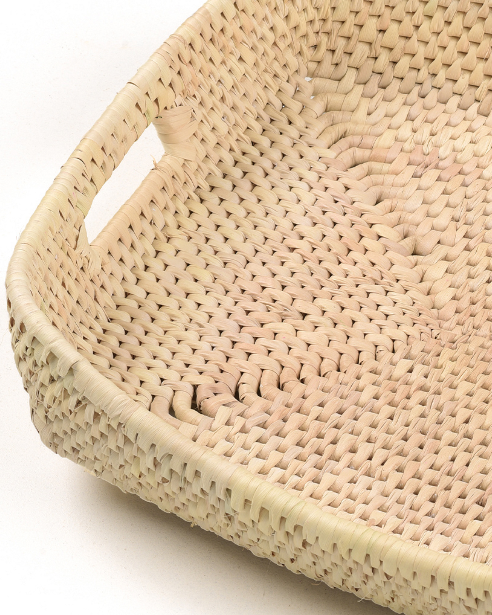 Close-up of a woven basket with a white background