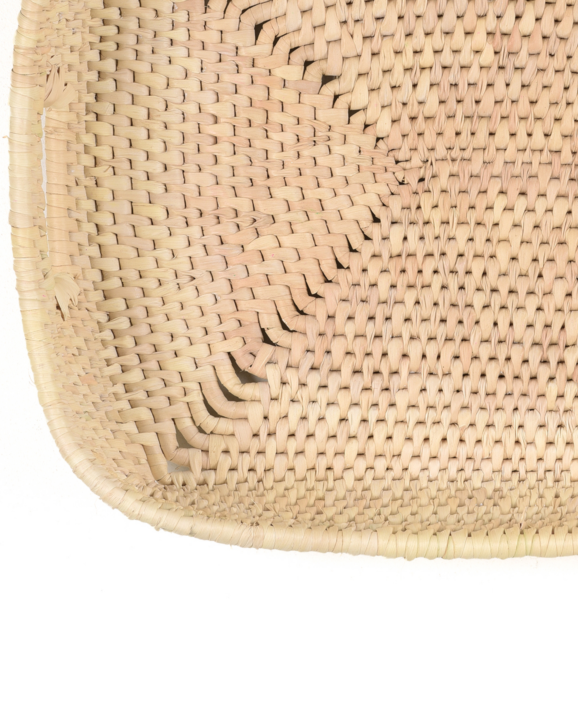 Close-up of a woven natural material product on a white background