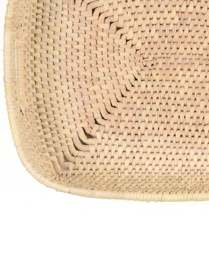 Close-up of a woven natural material product on a white background