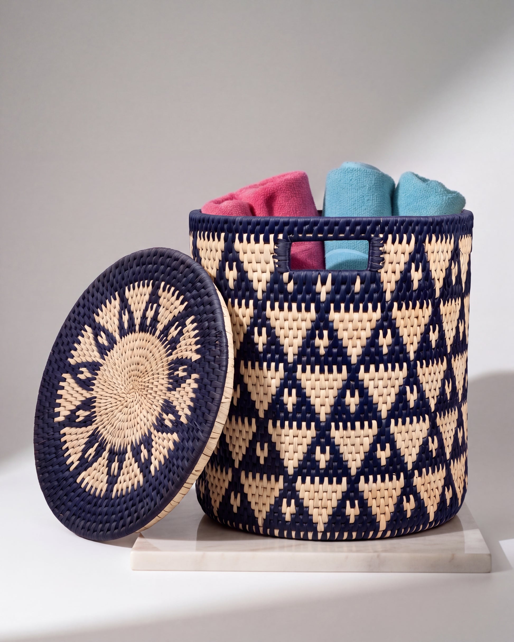 Handwoven navy blue and natural date-leaf storage basket with matching lid and handles