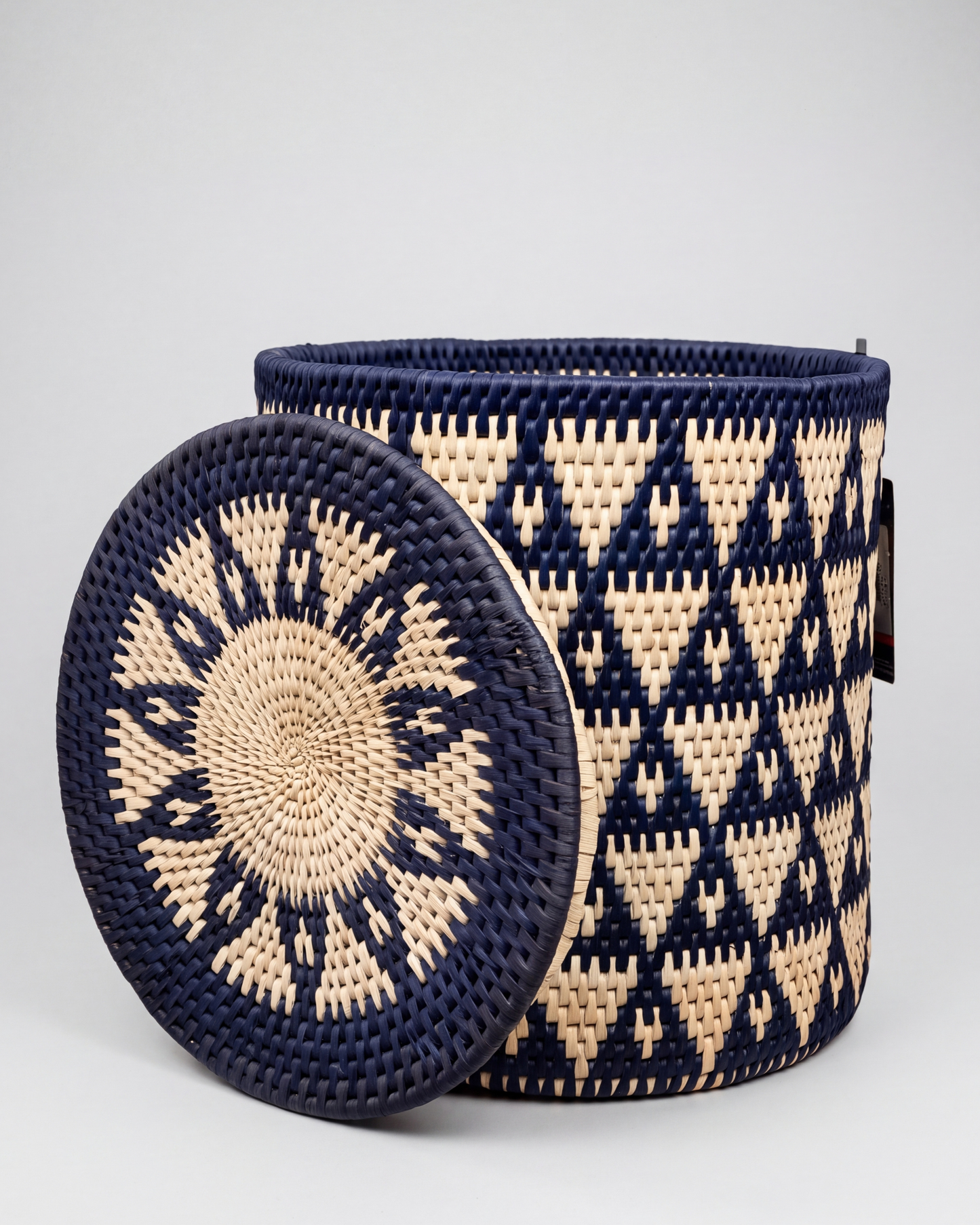 Handwoven navy blue and natural date-leaf storage basket with matching lid and handles