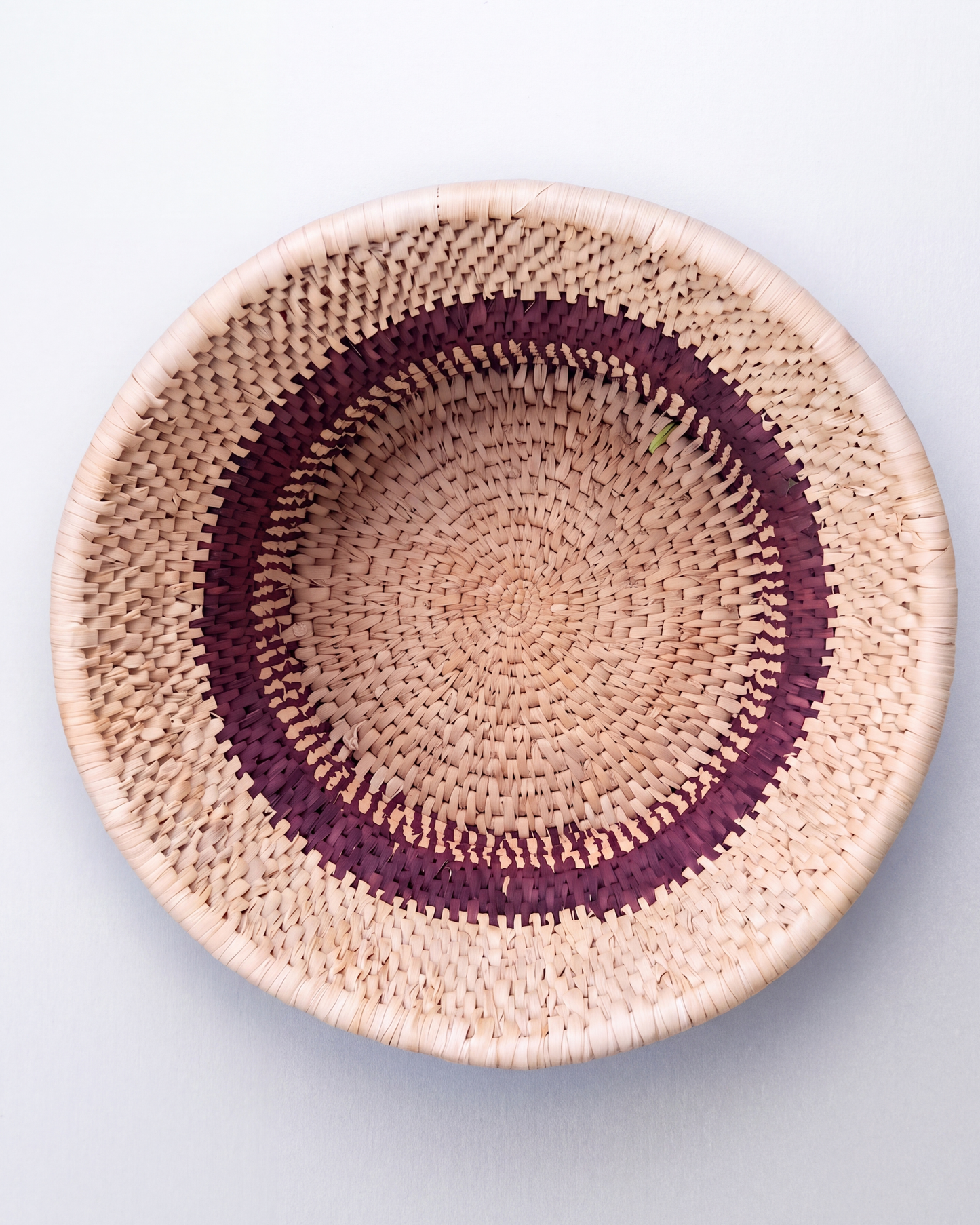 Multipurpose handwoven date-leaf basket with maroon and natural woven pattern