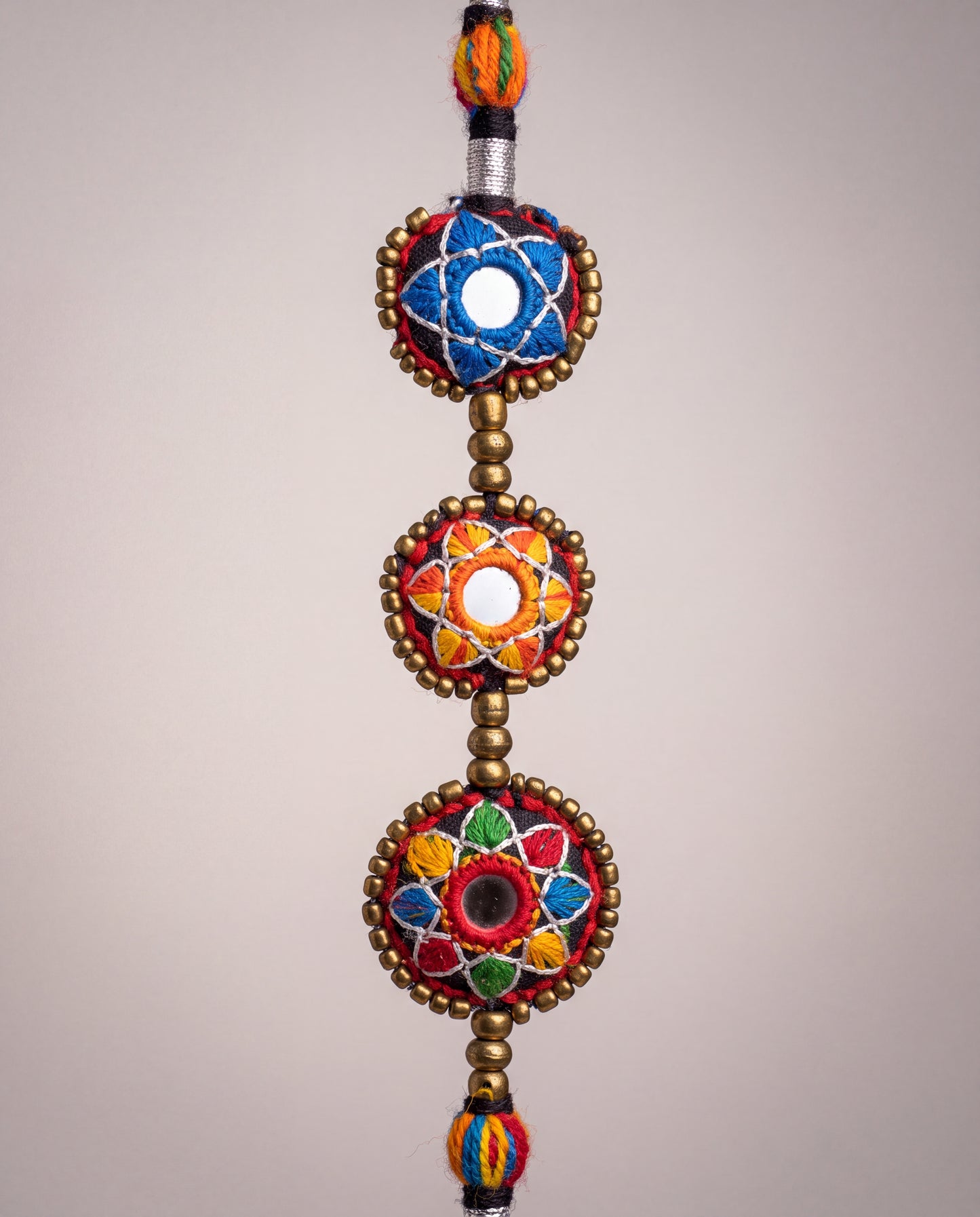 Handmade Balochi mirror flower necklace with colorful embroidered floral motifs, golden beads, silver thread, and traditional artisan craftsmanship from Pakistan.