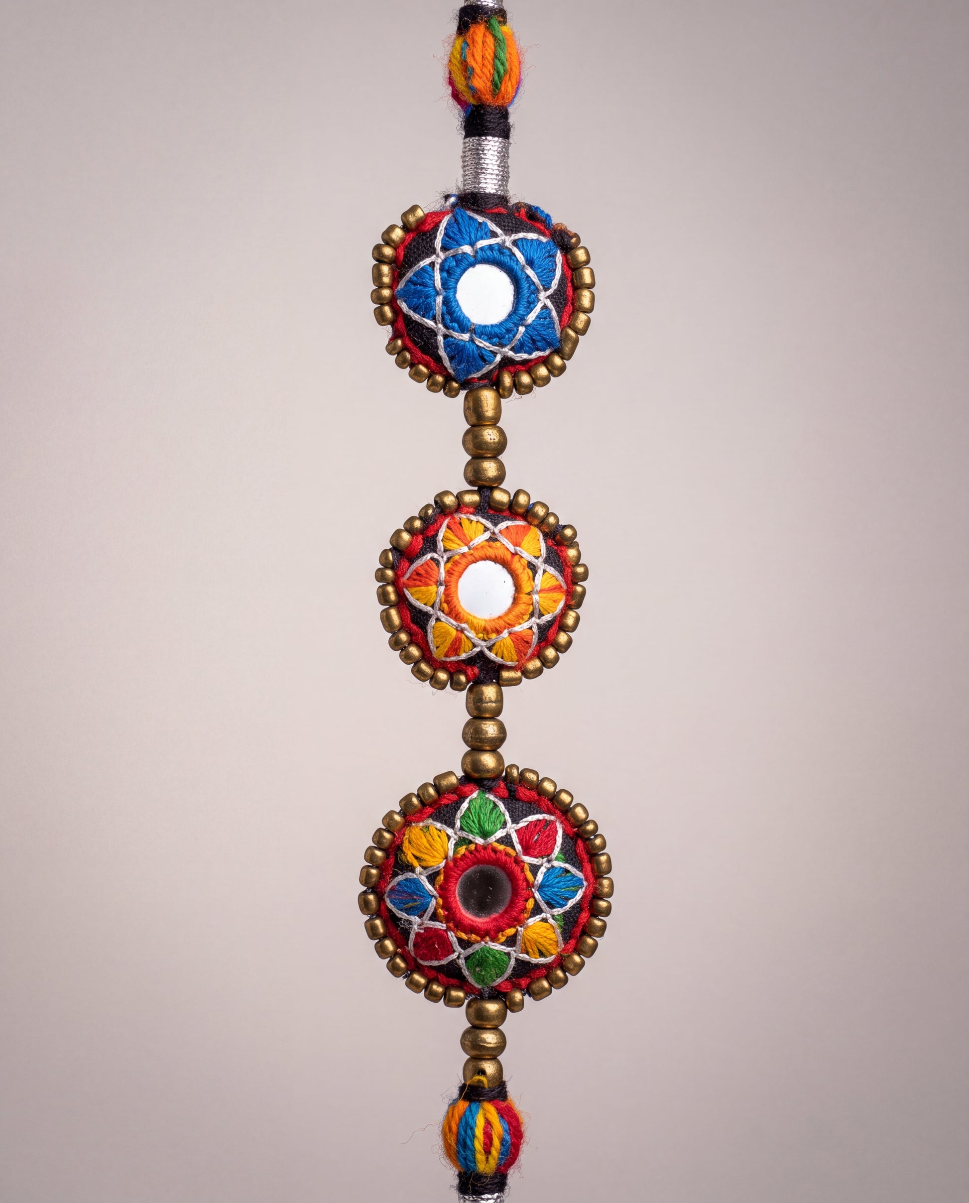 Handmade Balochi mirror flower necklace with colorful embroidered floral motifs, golden beads, silver thread, and traditional artisan craftsmanship from Pakistan.